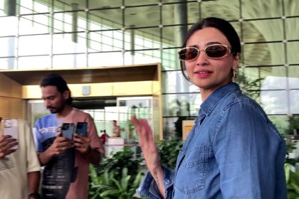 Daisy Shah spotted at Mumbai airport in casual chic outfit with denim jacket and white tee, carrying black leather bag and sunglasses