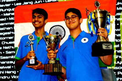 Madhav Gopal Kamath holding World Youth Scrabble Champion 2025 trophy after winning the championship in Kuala Lumpur.