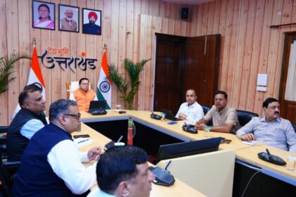 "Under-construction road in Uttarakhand with workers and machinery repairing potholes after monsoon season."