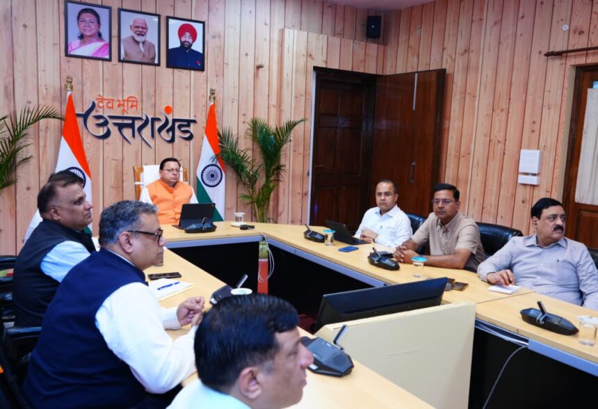 "Under-construction road in Uttarakhand with workers and machinery repairing potholes after monsoon season."