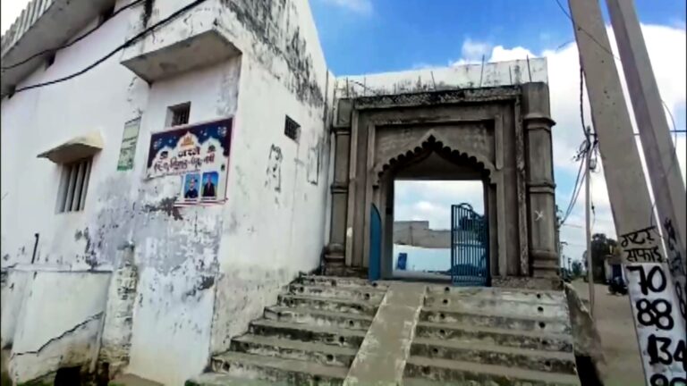 Bulldozer removing part of Gausul Wara Masjid in Sambhal, Uttar Pradesh, with police and paramilitary forces present during demolition
