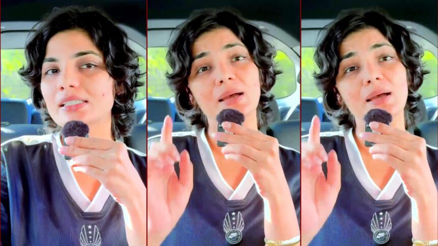 Neha Singh Rathore expressing her views with a microphone, satirical commentary on Bhojpuri singers entering Bihar politics