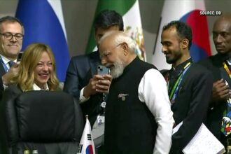 PM Narendra Modi and Italian PM Giorgia Meloni sharing a candid, smiling conversation during G20 Summit 2025 in Johannesburg, capturing global diplomatic attention.
