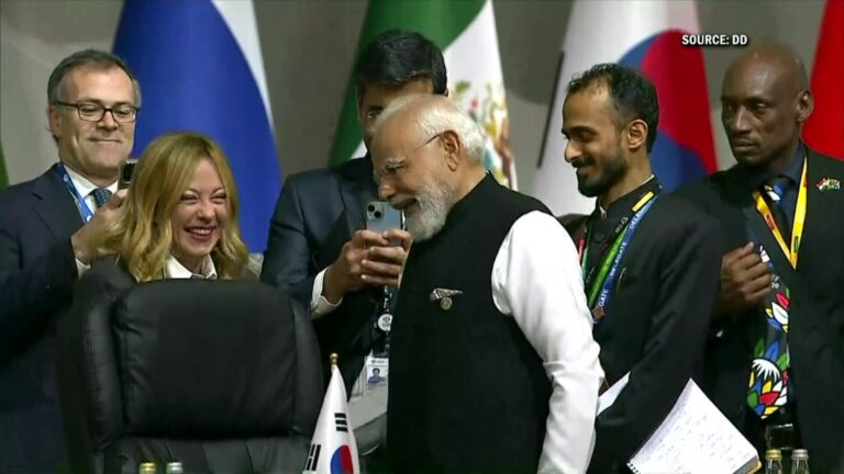 PM Narendra Modi and Italian PM Giorgia Meloni sharing a candid, smiling conversation during G20 Summit 2025 in Johannesburg, capturing global diplomatic attention.