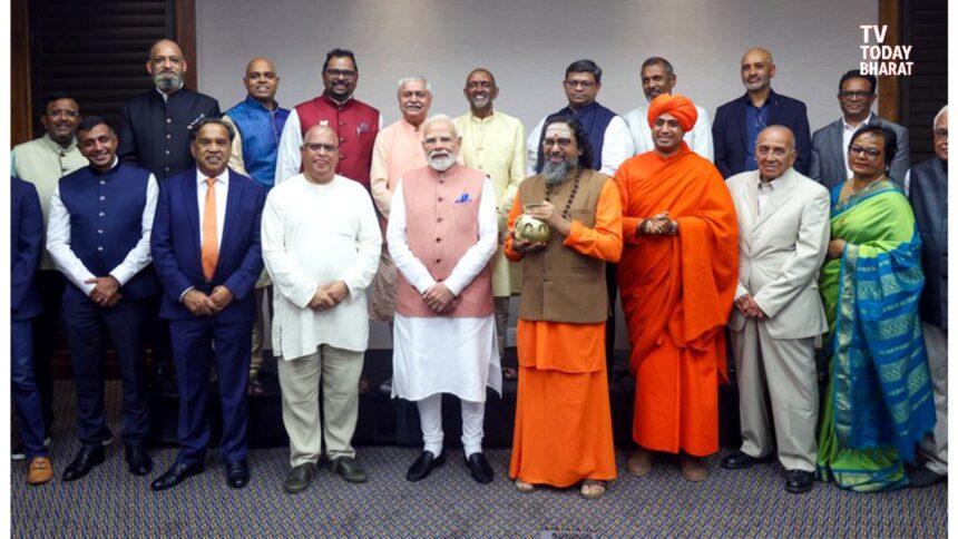 Prime Minister Narendra Modi interacting with Indian community leaders in Johannesburg during his South Africa visit for the G20 Summit.