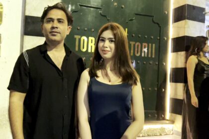 Riva Arora spotted outside Torii Restaurant in Mumbai, posing in a glamorous black-and-gold outfit with a radiant smile and confident style.