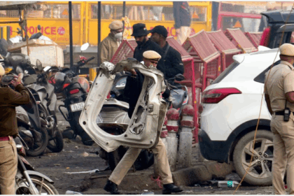 Delhi Red Fort Metro blast scene with damaged Hyundai i20 car, emergency teams at site, NIA investigation underway.