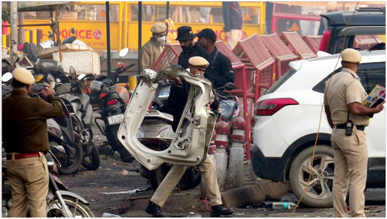 Delhi Red Fort Metro blast scene with damaged Hyundai i20 car, emergency teams at site, NIA investigation underway.