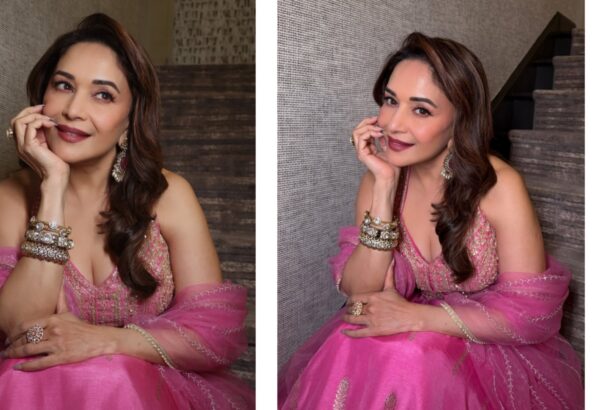 Madhuri Dixit smiling gracefully in a pink lehenga while posing for Instagram photos, showcasing her elegant traditional look