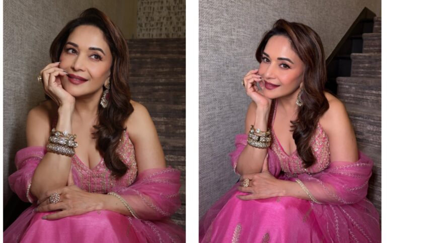 Madhuri Dixit smiling gracefully in a pink lehenga while posing for Instagram photos, showcasing her elegant traditional look