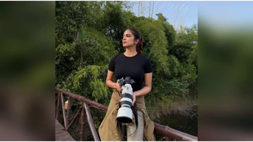 Malavika Mohanan smiling during her Tadoba safari with camera full of tiger photos