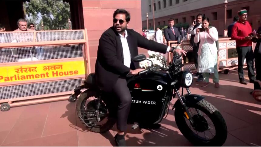 Congress leader Vamsi Gaddam arrives at Parliament on an electric bike during the Winter Session, highlighting pollution and environmental concerns.