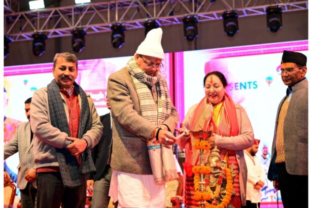 Chief Minister Pushkar Singh Dhami addressing people at Nainital Winter Carnival 2025 with Uttarakhand folk cultural performances in the background.