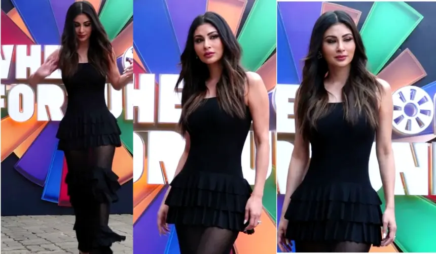 Mouni Roy posing in a glamorous and elegant outfit on the Wheel of Fortune set in Mumbai during the show shoot.