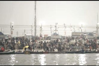 Devotees taking holy dip at Triveni Sangam during Magh Mela 2026 in Prayagraj