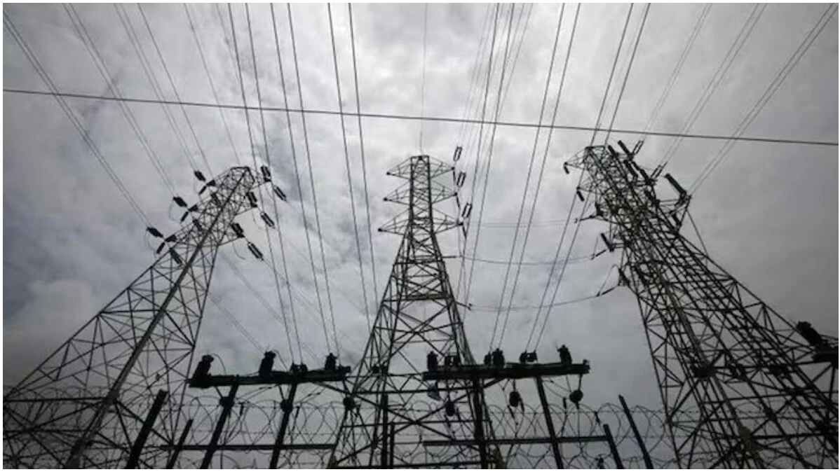 Delhi Electricity Price Hike: Electricity meter and power transmission lines representing hike and increased electricity bills in Delhi.
