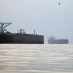 Commercial oil tankers and cargo ships passing through the Hormuz Strait as Oman discusses possible shipping service charges