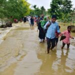 Assam Flood 2026: Rescue teams assisting flood-affected residents in Assam as floodwaters inundate villages.
