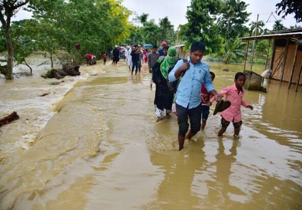 Assam Flood 2026: Rescue teams assisting flood-affected residents in Assam as floodwaters inundate villages.