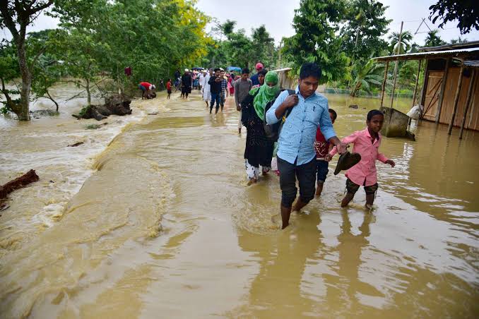 Assam Flood 2026: Rescue teams assisting flood-affected residents in Assam as floodwaters inundate villages.
