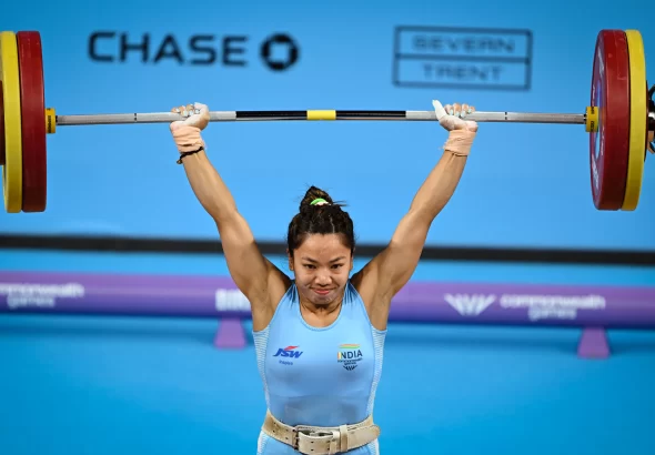 Mirabai Chanu Commonwealth Games celebrates after winning her third consecutive Commonwealth Games gold medal in women's weightlifting.
