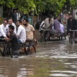 Gujarat Rain News: Rescue teams evacuating flood-affected residents during heavy rainfall in Gujarat as severe flooding disrupts roads.