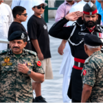 Pakistani Ranger Salutes Indian Officer: Pakistani Ranger formally saluting an Indian officer during a border ceremony at the Attari-Wagah crossing
