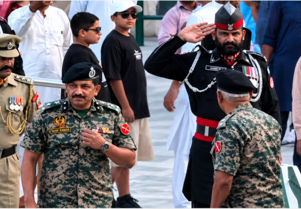 Pakistani Ranger Salutes Indian Officer: Pakistani Ranger formally saluting an Indian officer during a border ceremony at the Attari-Wagah crossing