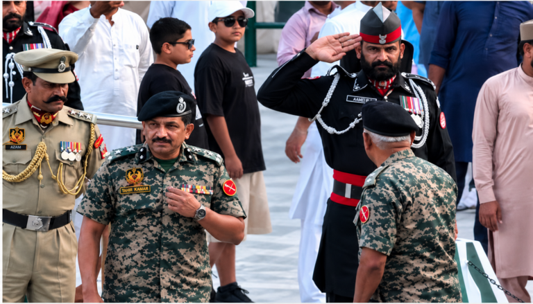 Pakistani Ranger Salutes Indian Officer: Pakistani Ranger formally saluting an Indian officer during a border ceremony at the Attari-Wagah crossing